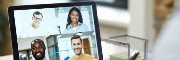 Young office worker having video conference with his colleagues and making notes in the notebooks